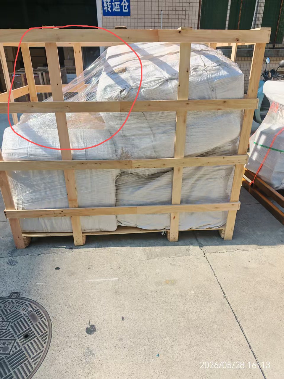 Wooden crate with a package leaning out of position, marked during a warehouse check