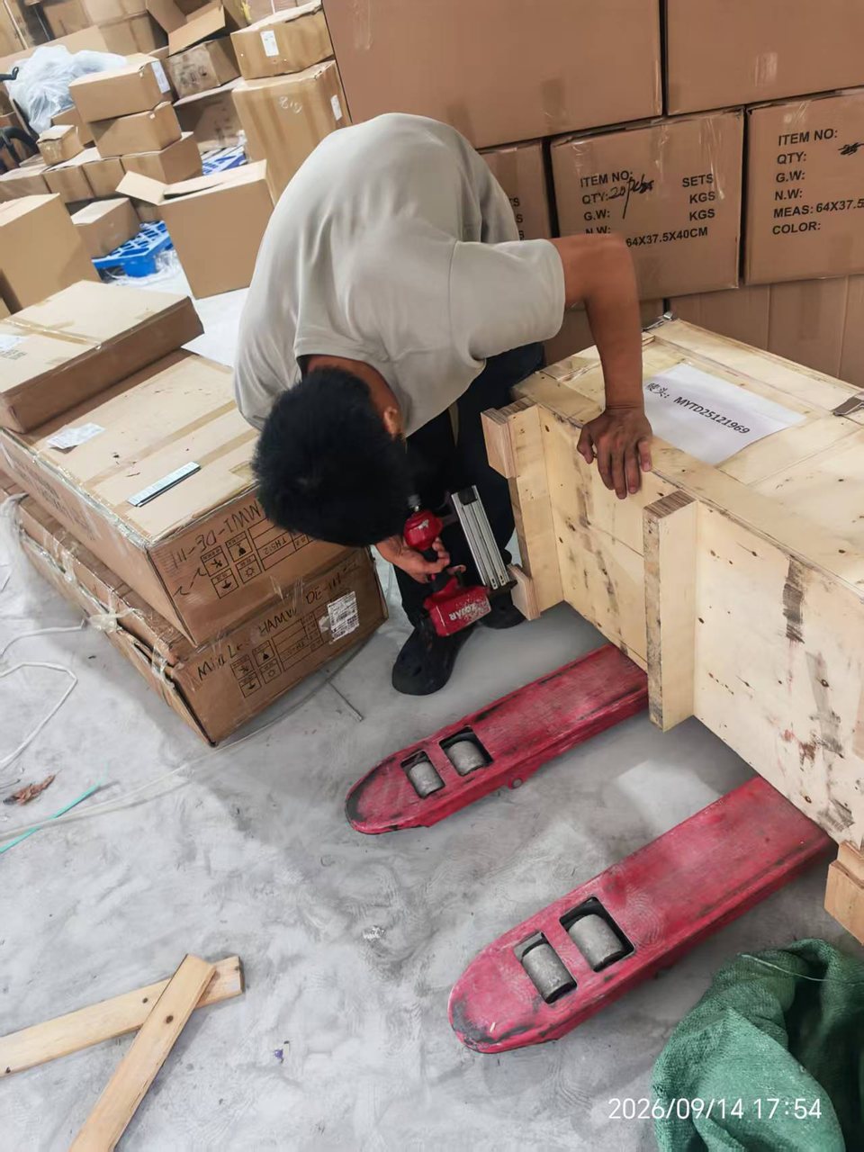 Reinforcing a wooden crate with a nail gun before export